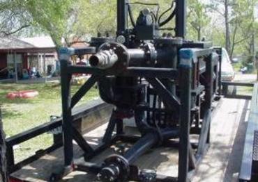 A black machine sitting on top of cement.